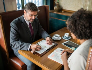 Matrimonial detective consulting a client on marriage verification