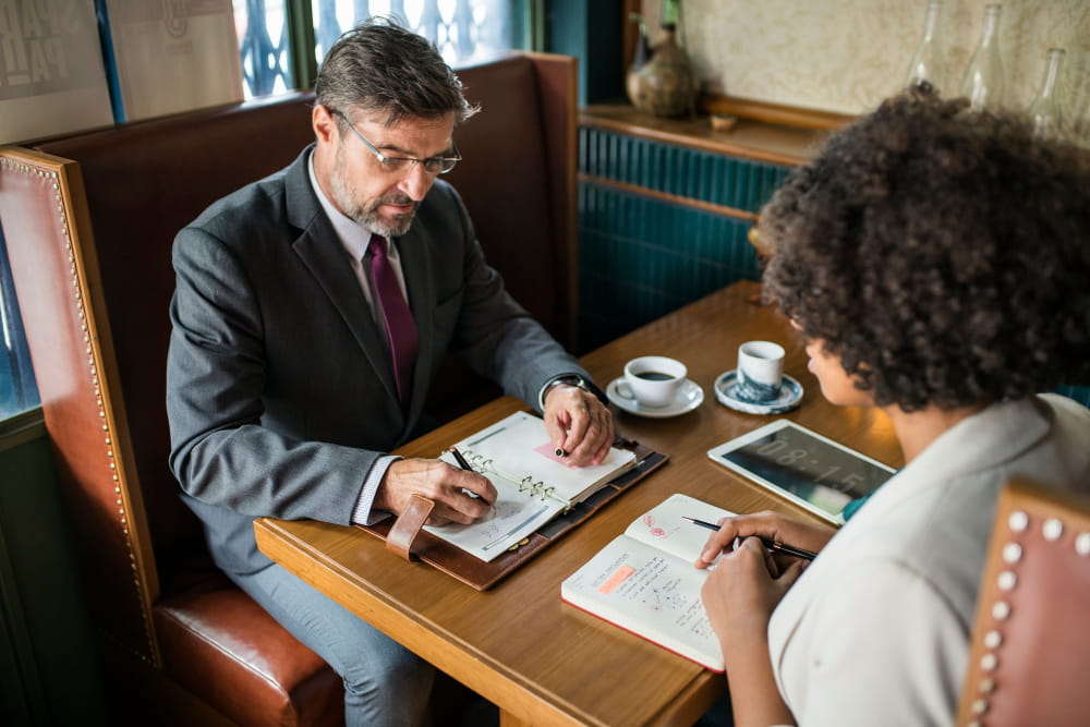Matrimonial detective consulting a client on marriage verification